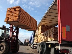 Forklift skills shown as timber is loaded onto a truck by a forklift