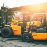 Forklift skills demonstrated by two heavy-duty forklifts ready for outdoor use